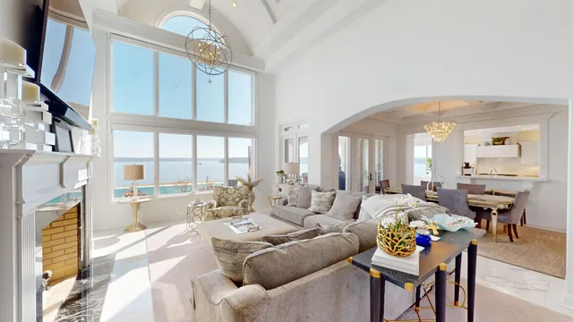 a living room with furniture fireplace and a large window