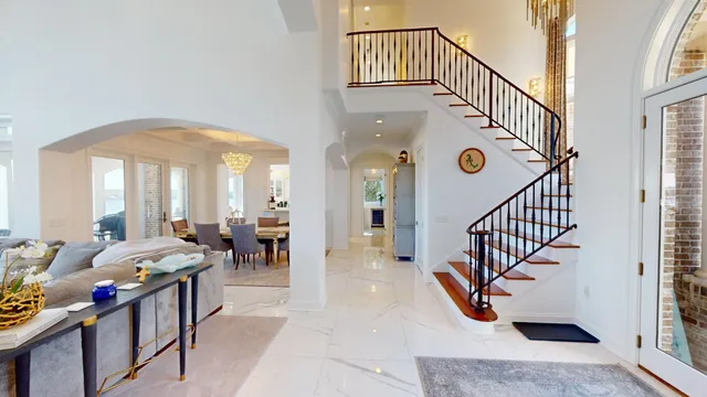 a view of an entryway wooden floor and windows