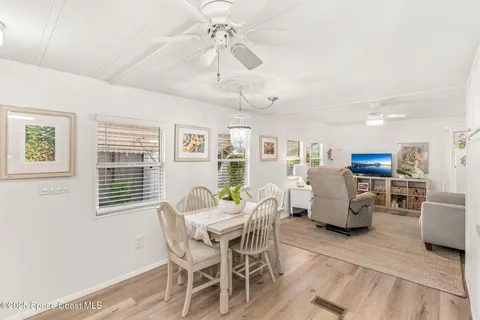 a kitchen with stainless steel appliances white cabinets and wooden floor