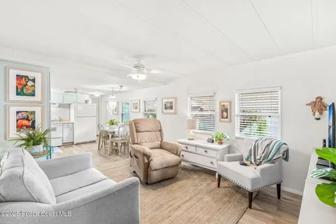 a spacious bedroom with a bed and a chandelier