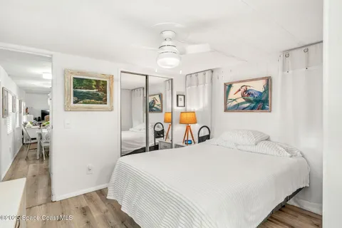 a spacious bedroom with a bed and a chandelier