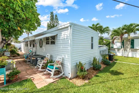 a view of a chair and table in the backyard