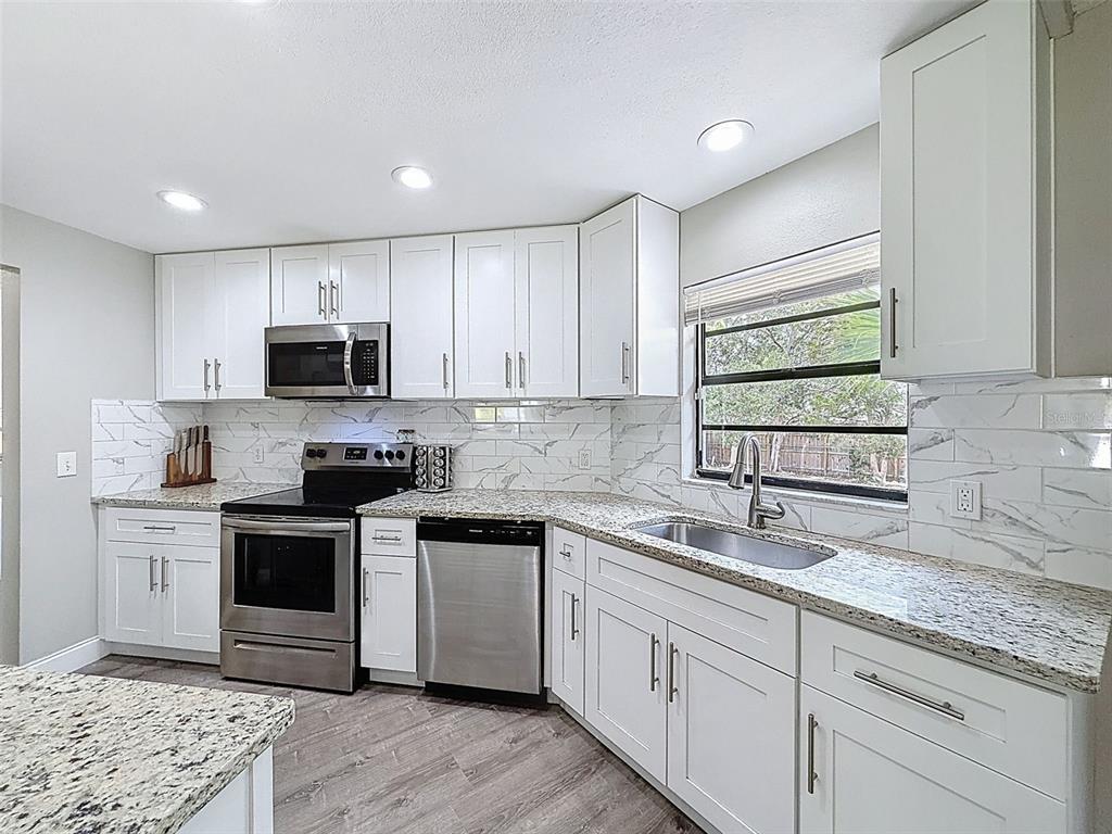 5384 Baldock Avenue Spring Hill, FL 34608 - Photo 3 of 51 a kitchen with appliances cabinets and a sink