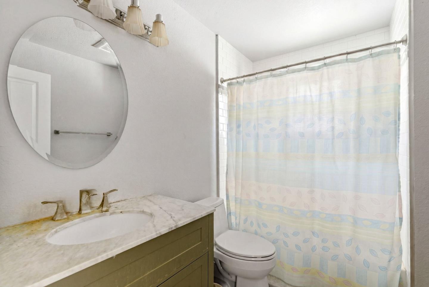 1460 Tucker Road Scotts Valley, CA 95066 - Photo 10 of 32 a bathroom with a granite countertop sink a toilet and a mirror