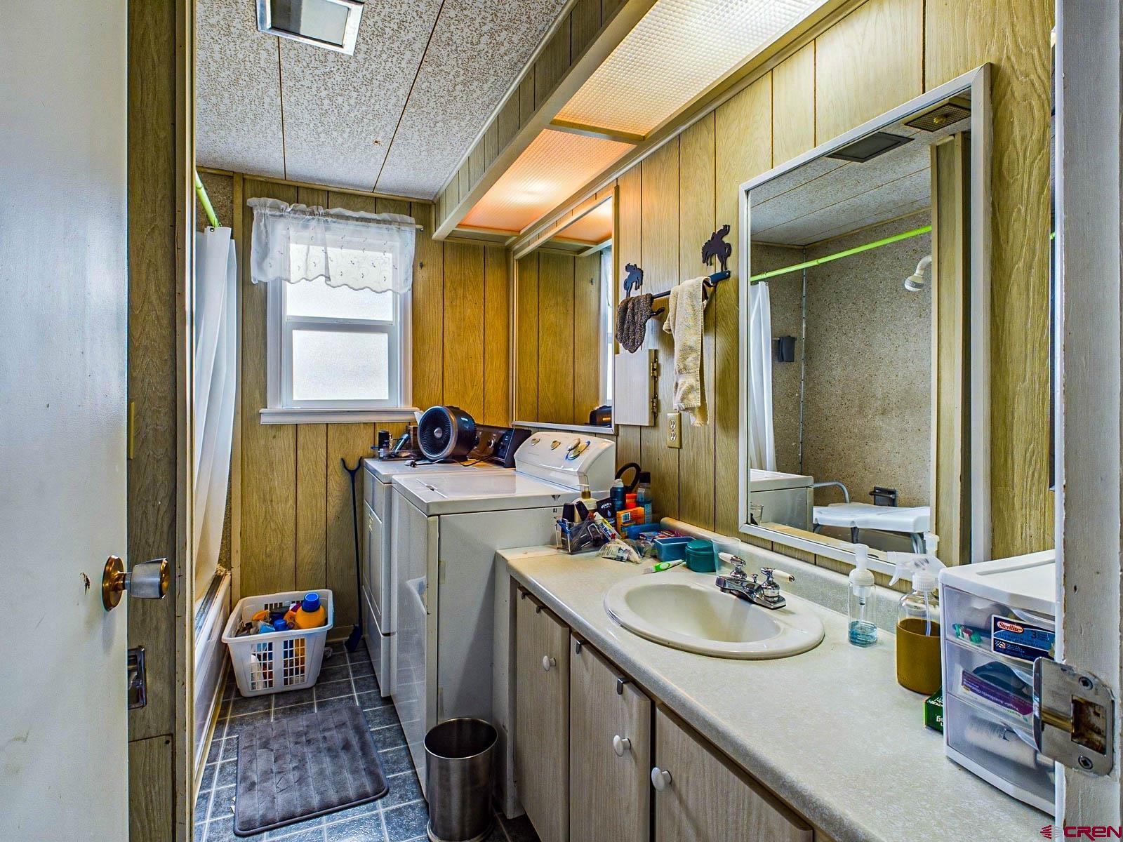 18236 Kiser Creek Road Cedaredge, CO 81413 - Photo 18 of 35 a bathroom with a sink double vanity and a mirror