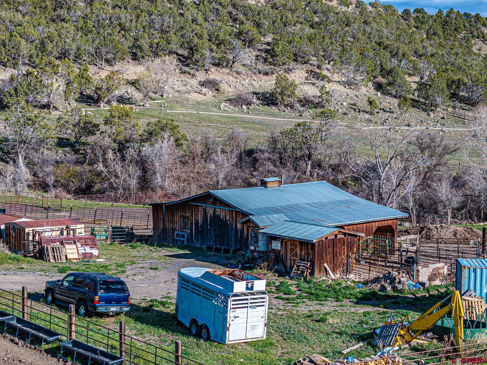 18236 Kiser Creek Road Cedaredge, CO 81413 - Photo 24 of 35 an aerial view of a house with garden space and deck