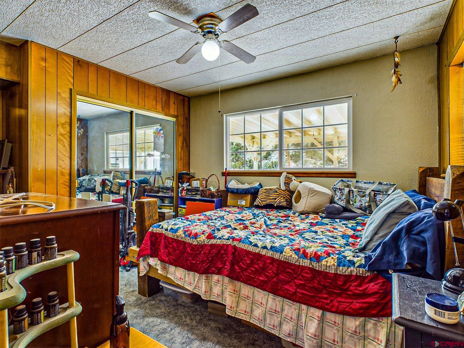 18236 Kiser Creek Road Cedaredge, CO 81413 - Photo 10 of 35 a bedroom with bed and wooden floor