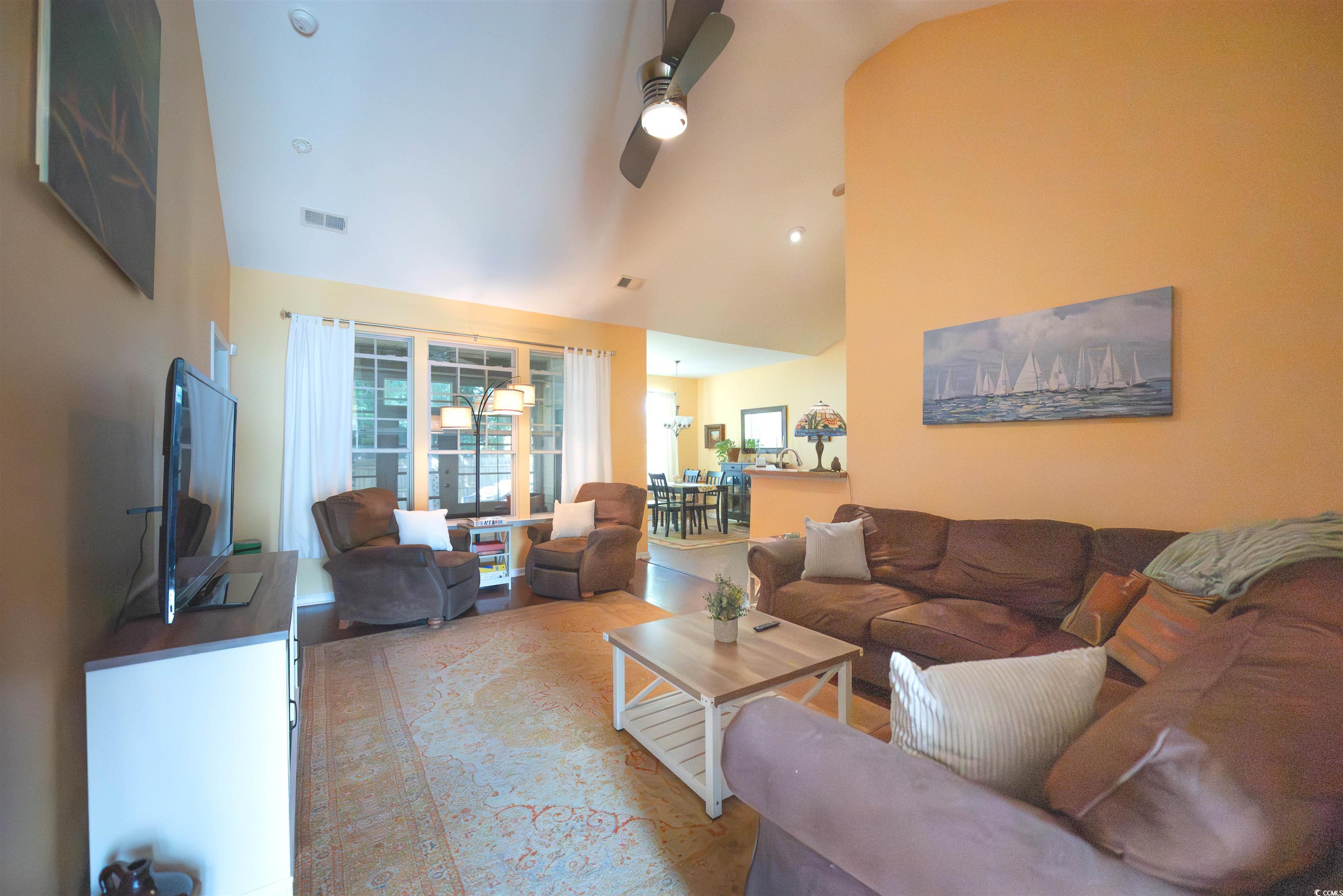 209 Golden Oaks Drive Murrells Inlet, SC 29576 - Photo 11 of 40 Living area with high vaulted ceiling and a ceiling fan