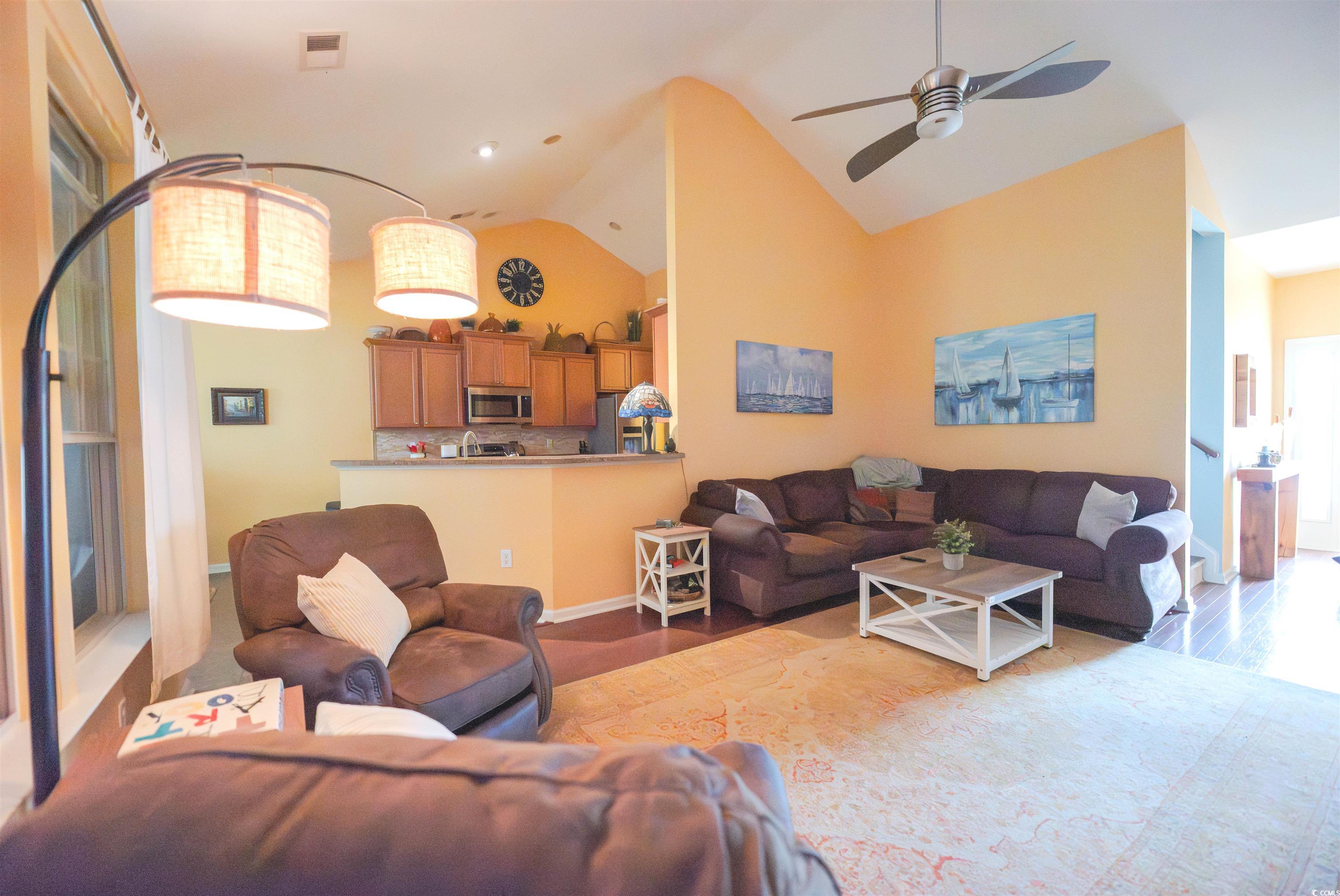 209 Golden Oaks Drive Murrells Inlet, SC 29576 - Photo 12 of 40 Living room with high vaulted ceiling, a ceiling fan, and wood finished floors