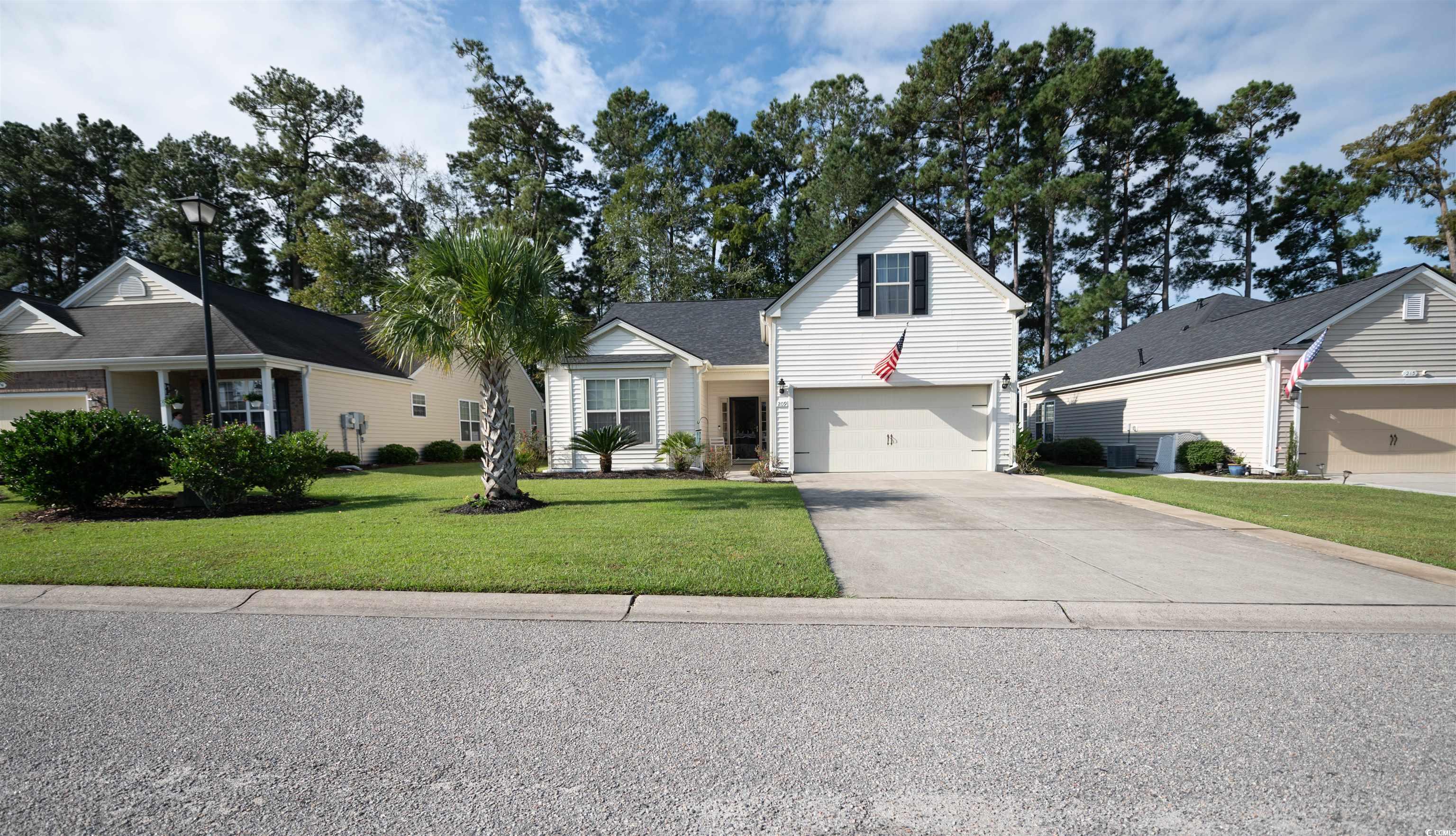 209 Golden Oaks Drive Murrells Inlet, SC 29576 - Photo 3 of 40 Traditional-style home featuring driveway, a front lawn, and an attached garage