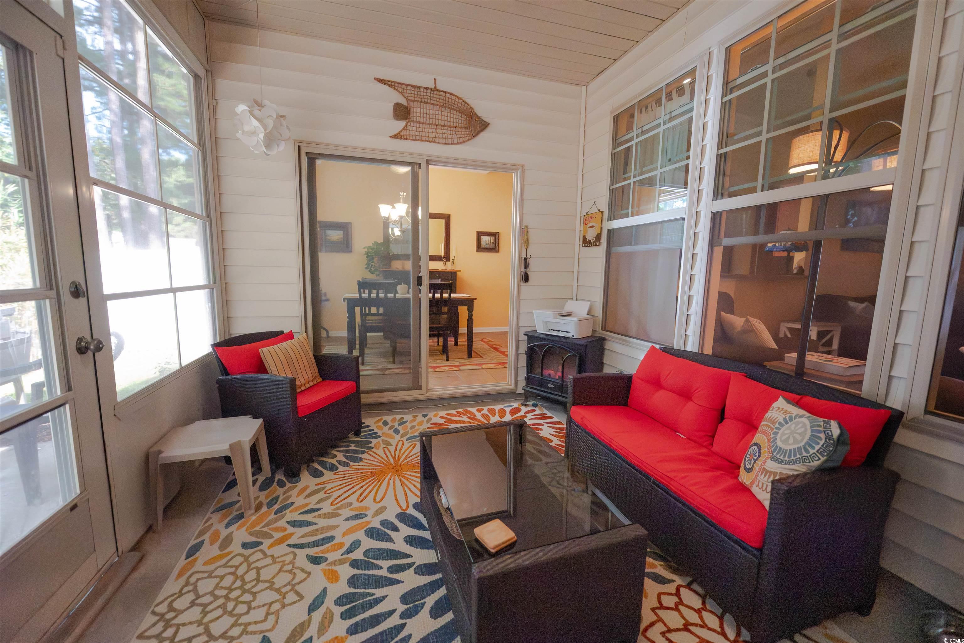 209 Golden Oaks Drive Murrells Inlet, SC 29576 - Photo 32 of 40 Sunroom / solarium featuring french doors, wood walls, and wooden ceiling