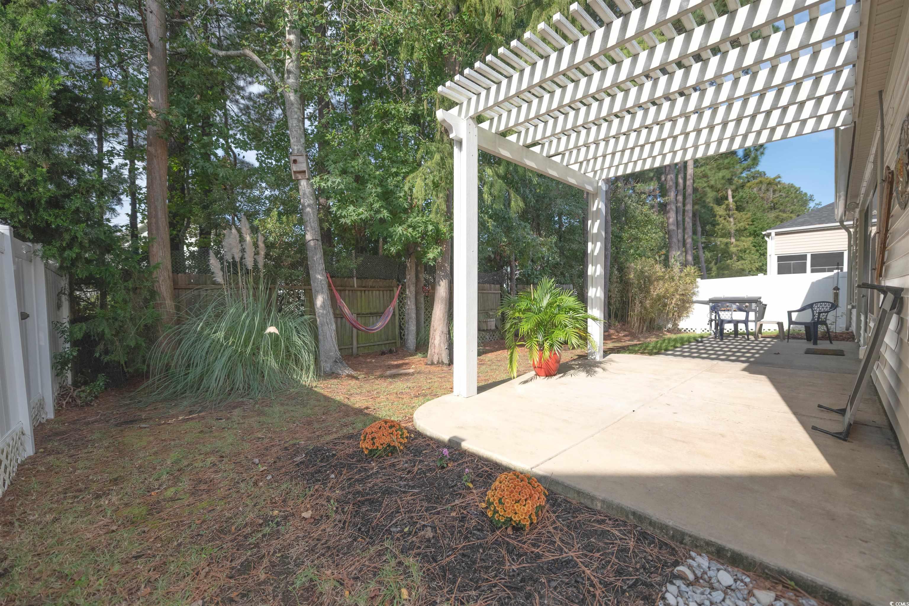 209 Golden Oaks Drive Murrells Inlet, SC 29576 - Photo 34 of 40 Fenced backyard featuring a patio area and a pergola