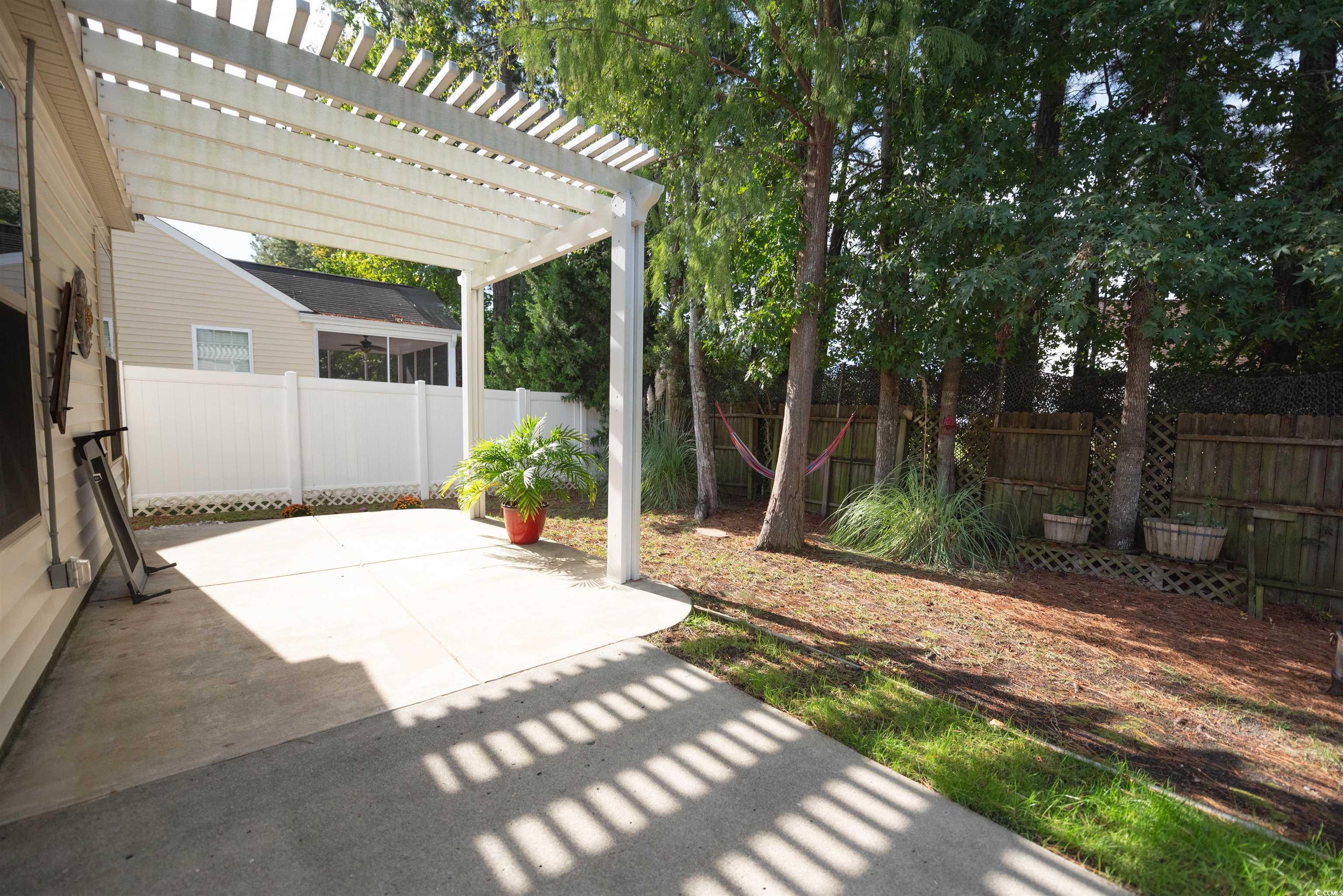 209 Golden Oaks Drive Murrells Inlet, SC 29576 - Photo 36 of 40 Fenced backyard featuring a pergola and a patio