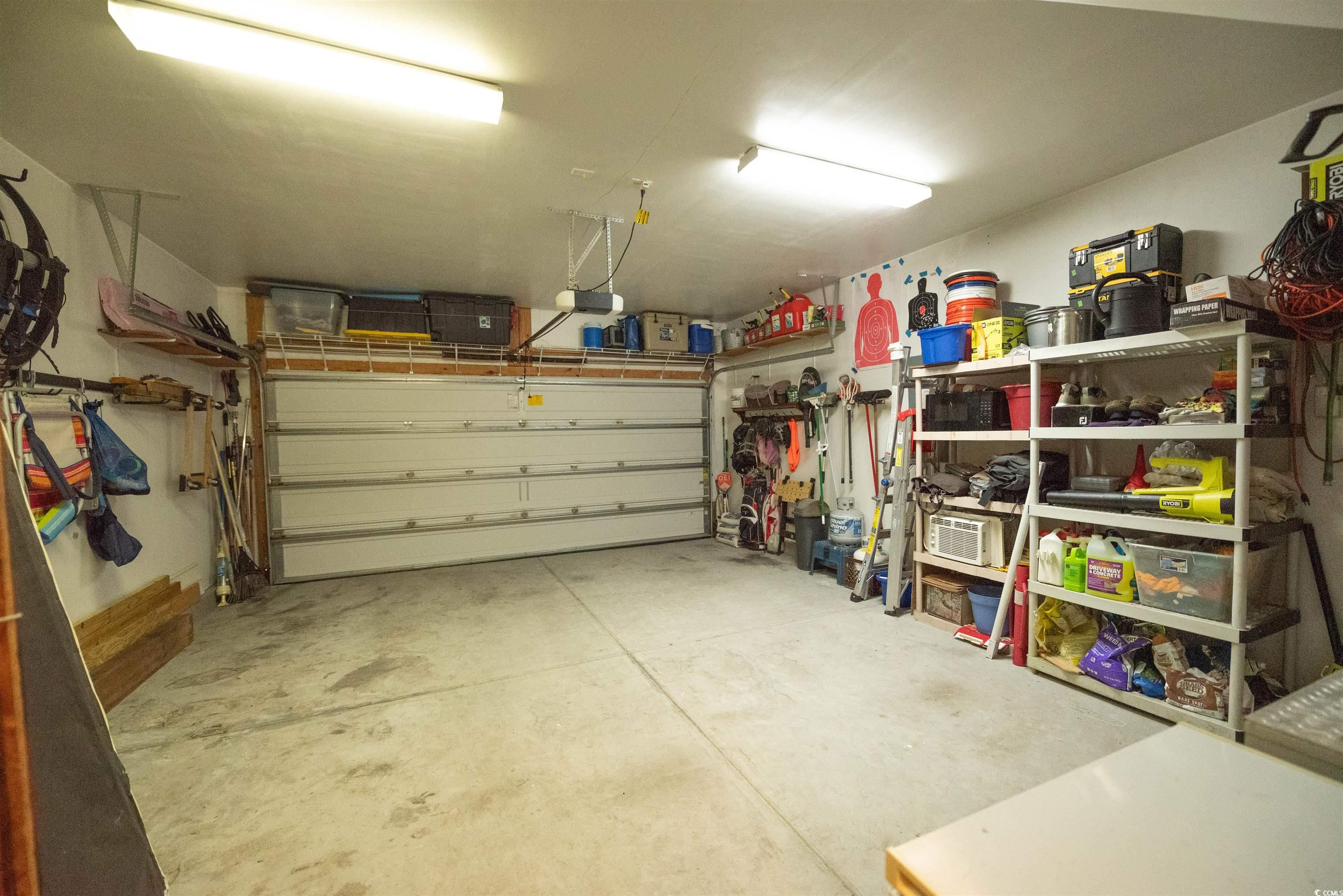 209 Golden Oaks Drive Murrells Inlet, SC 29576 - Photo 37 of 40 Garage featuring a garage door opener
