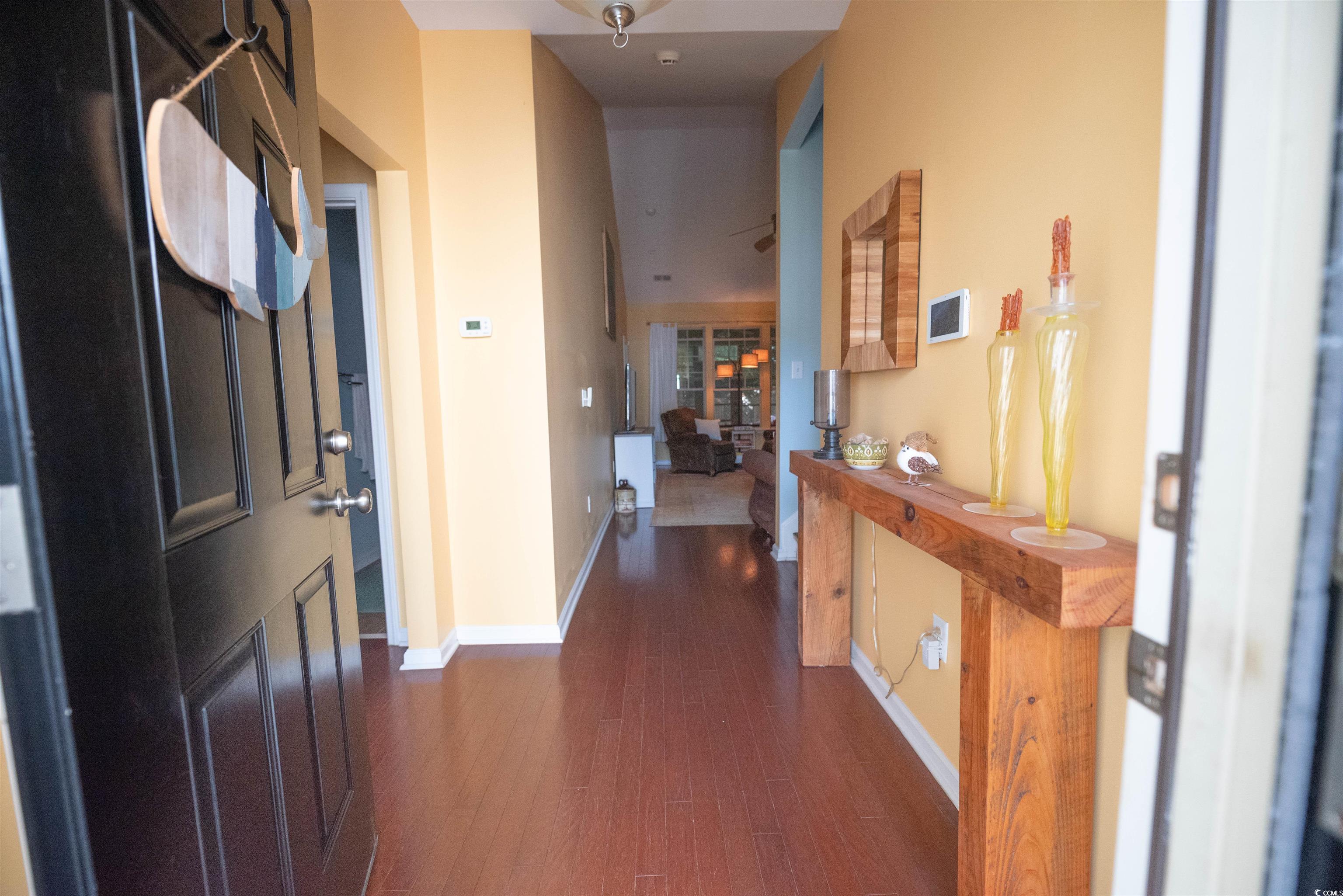 209 Golden Oaks Drive Murrells Inlet, SC 29576 - Photo 10 of 40 Foyer entrance featuring dark wood-style flooring and baseboards