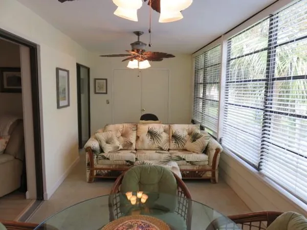 a living room with furniture chandelier and a window