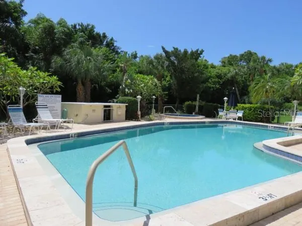 a view of a swimming pool with outdoor seating
