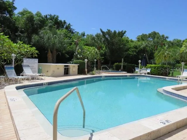 a view of a swimming pool with outdoor seating