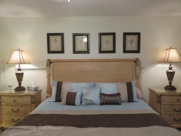 a living room with furniture and a lamp