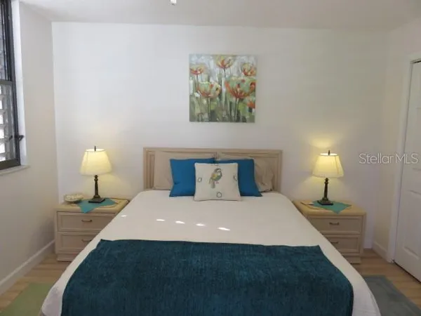 a bedroom with a bed and a lamp on table