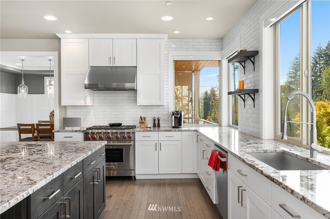 10406 Northeast 52nd Street Kirkland, WA 98033 - Photo 11 of 36 a kitchen with a stove top oven sink and cabinets