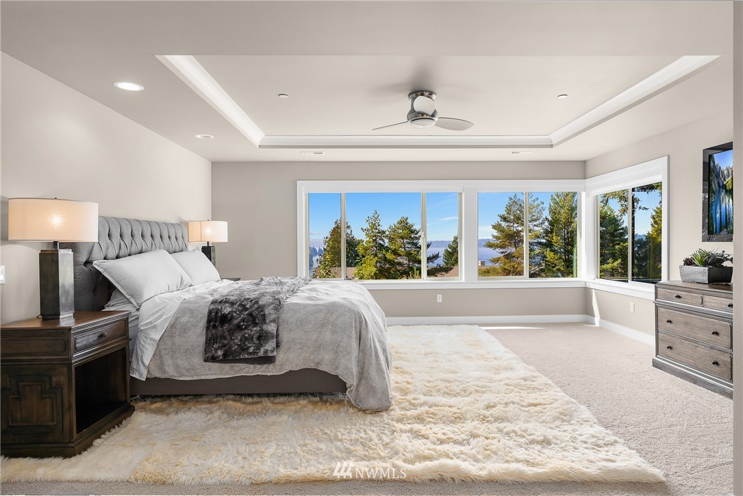 10406 Northeast 52nd Street Kirkland, WA 98033 - Photo 17 of 36 a spacious bedroom with a large bed and a large window