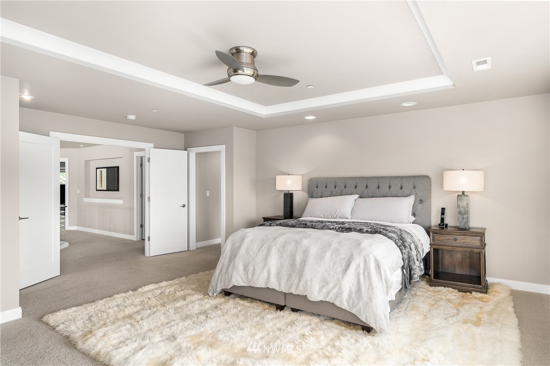 10406 Northeast 52nd Street Kirkland, WA 98033 - Photo 18 of 36 a spacious bedroom with a bed and a dresser