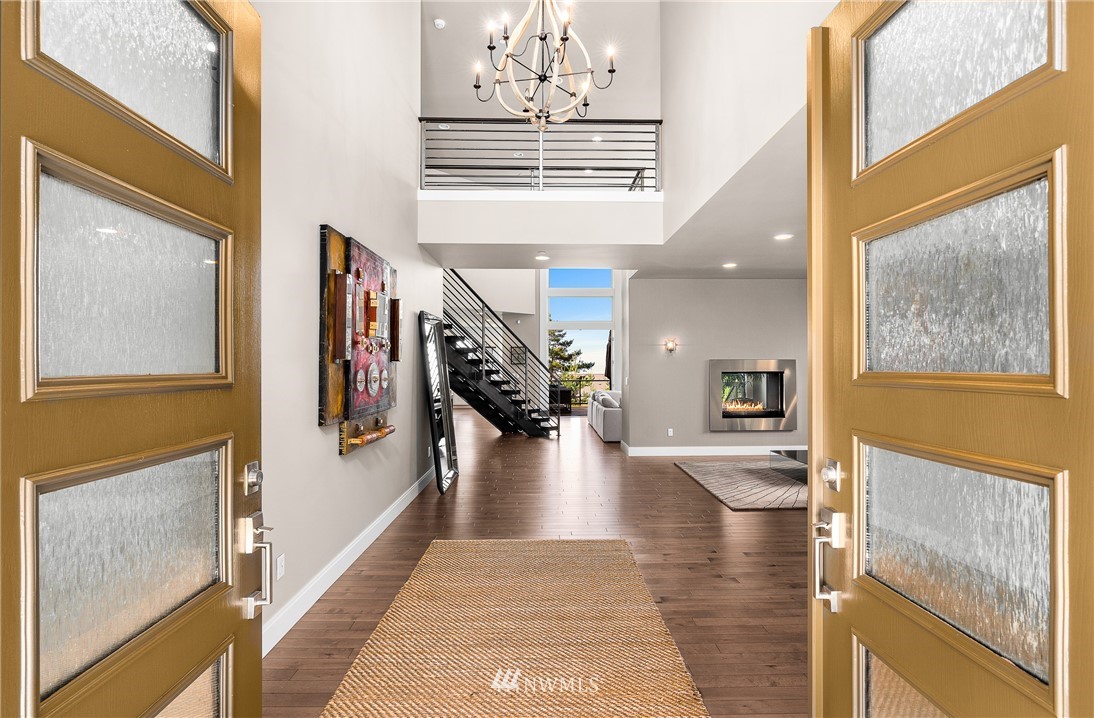 10406 Northeast 52nd Street Kirkland, WA 98033 - Photo 3 of 36 a view of an entryway with wooden floor and a livingroom