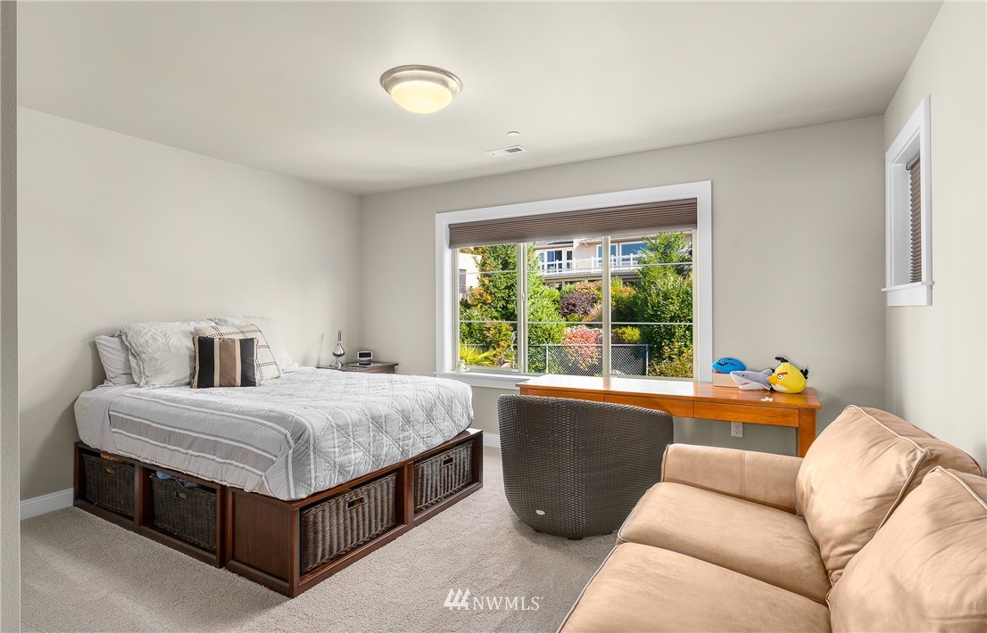 10406 Northeast 52nd Street Kirkland, WA 98033 - Photo 22 of 36 a bed room with a bed and a couch