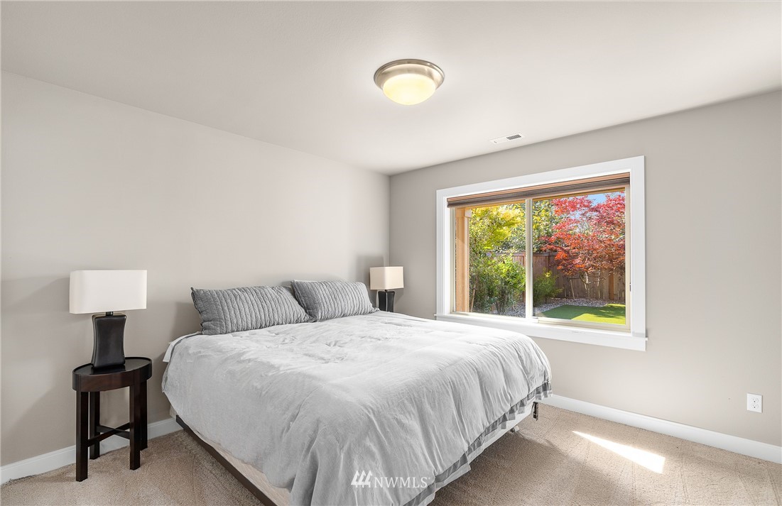 10406 Northeast 52nd Street Kirkland, WA 98033 - Photo 27 of 36 a bedroom with a bed and a lamp next to a window