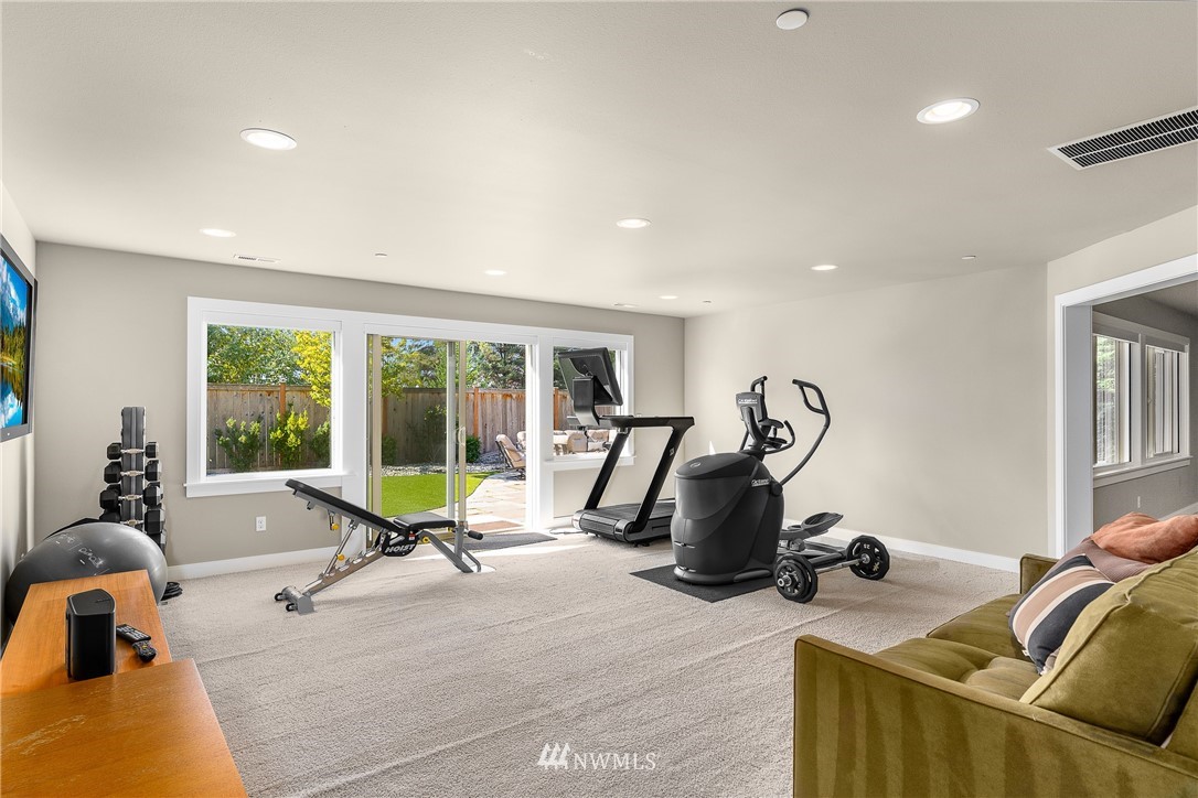 10406 Northeast 52nd Street Kirkland, WA 98033 - Photo 30 of 36 a living room with furniture gym equipment and a large window