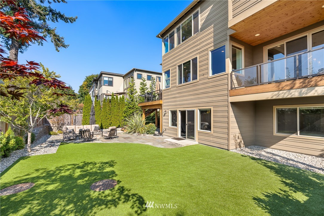 10406 Northeast 52nd Street Kirkland, WA 98033 - Photo 31 of 36 a front view of a house with a yard and garage