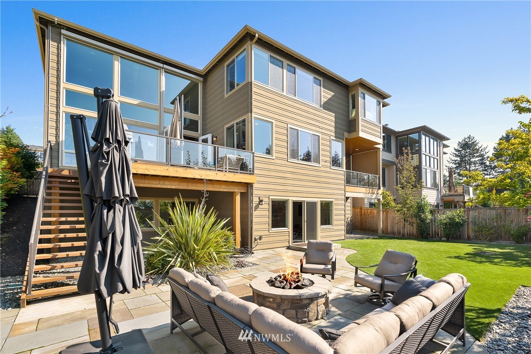 10406 Northeast 52nd Street Kirkland, WA 98033 - Photo 35 of 36 a view of a patio with couches table and chairs with potted plants and big yard