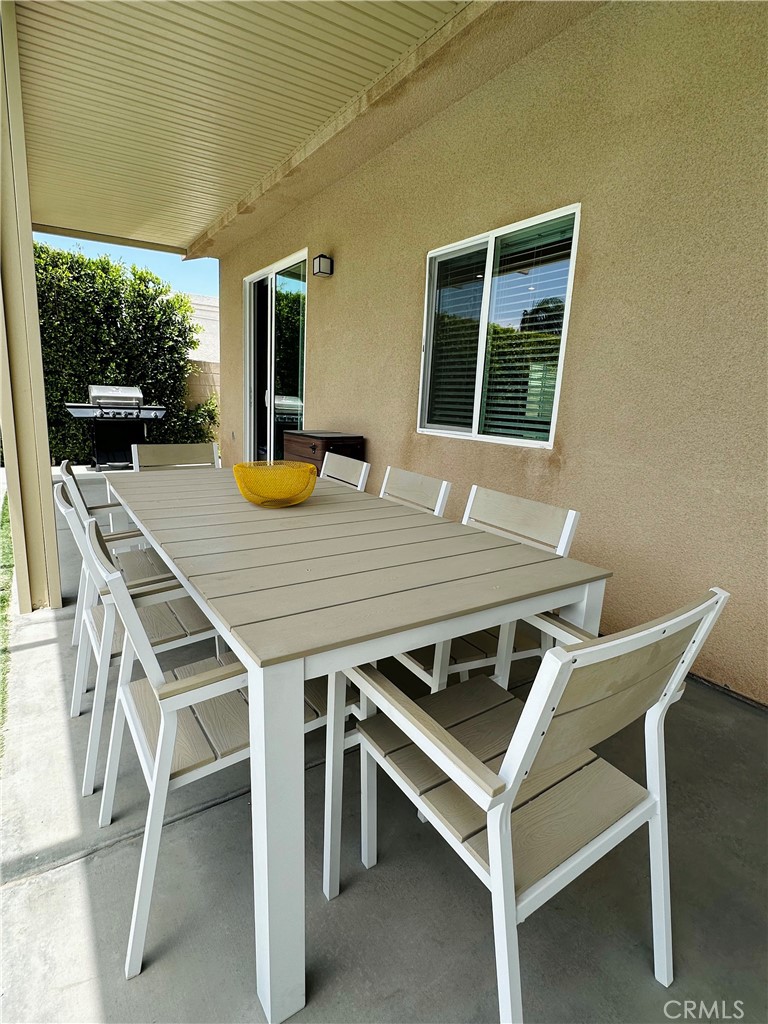 68315 Modalo Road Cathedral City, CA 92234 - Photo 12 of 18 a view of a dinning table and chairs in the patio