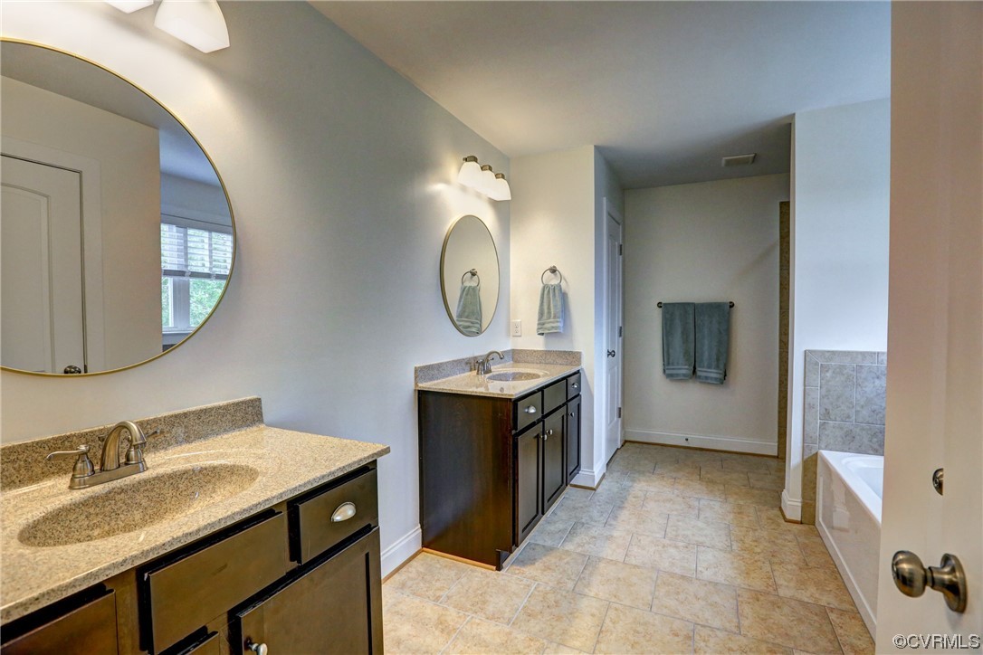 2007 Colwyn Bay Drive Midlothian, VA 23112 - Photo 33 of 49 a spacious bathroom with a sink vanity and a mirror