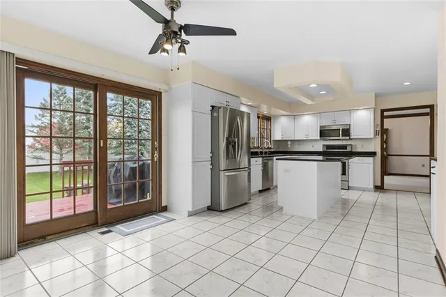 a kitchen with stainless steel appliances a refrigerator sink and cabinets