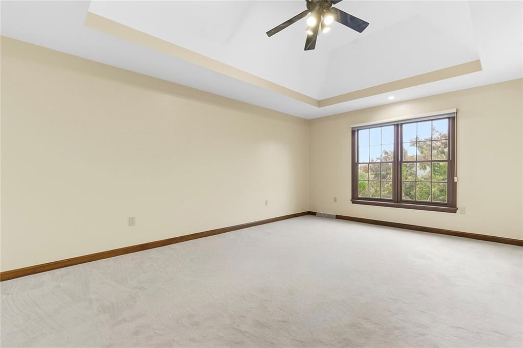370 Cobblestone Circle McKees Rocks, PA 15136 - Photo 22 of 50 an empty room with a chandelier fan and windows