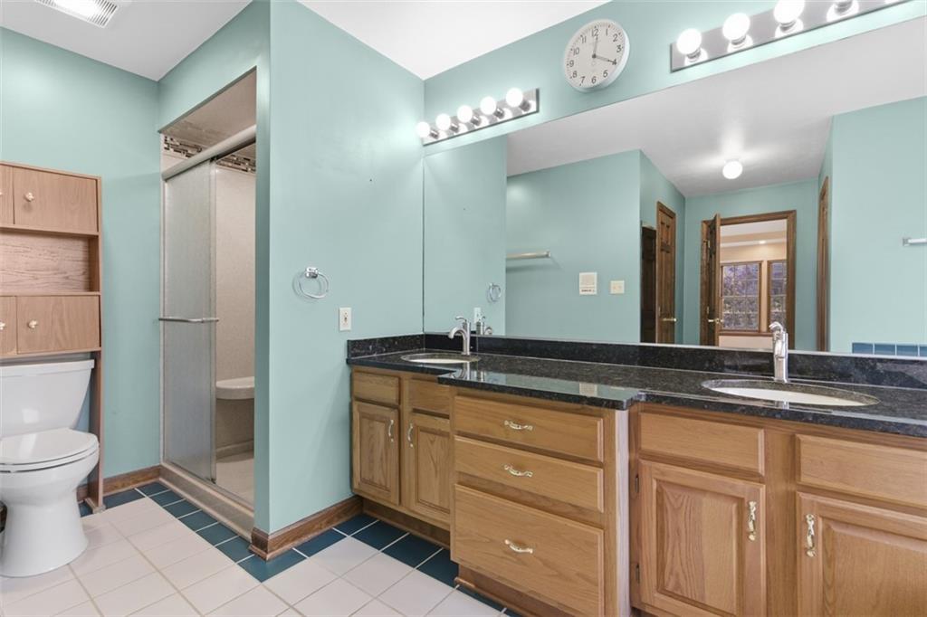 370 Cobblestone Circle McKees Rocks, PA 15136 - Photo 26 of 50 a bathroom with a granite countertop sink a toilet and a mirror