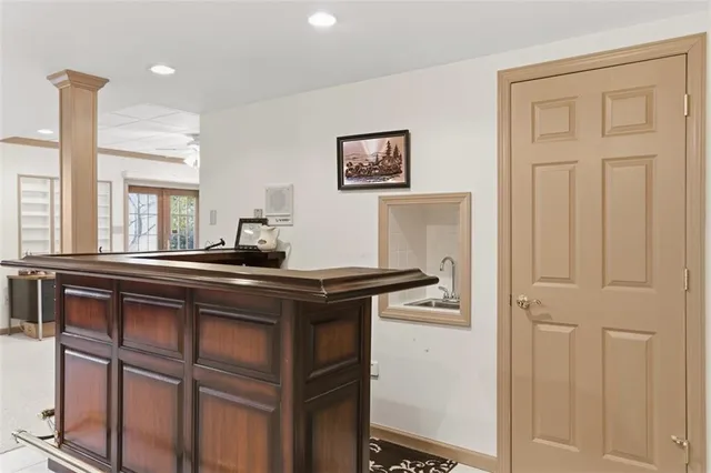 a kitchen with stainless steel appliances granite countertop white cabinets and window