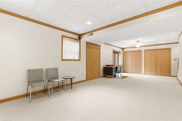 a view of a livingroom with furniture and a window