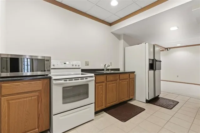 a kitchen with a stove top oven and refrigerator