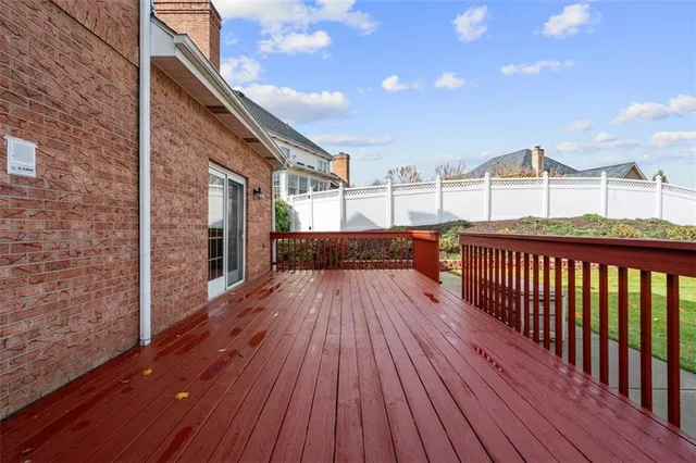 a view of balcony with wooden floor and fence