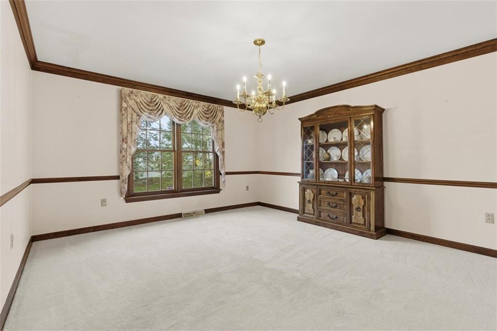 370 Cobblestone Circle McKees Rocks, PA 15136 - Photo 10 of 50 an empty room with windows and chandelier