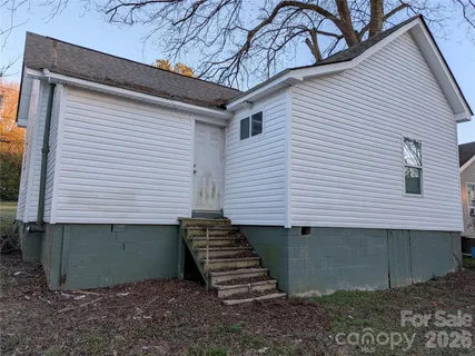 a view of a house with a yard and garage