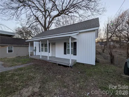 a view of a livingroom with a chandelier fan and a ceiling fan