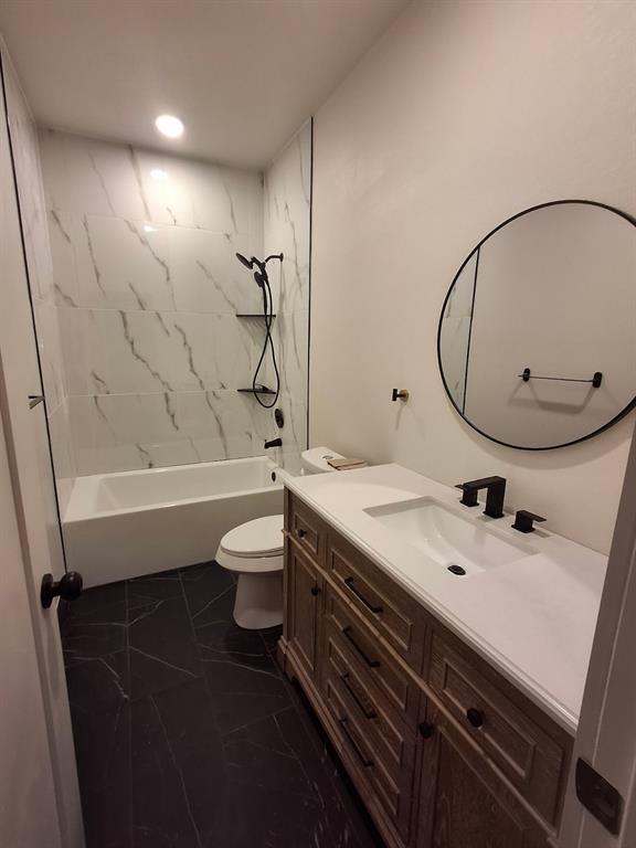 902 Chestnut Street Commerce, TX 75428 - Photo 13 of 18 a bathroom with a sink a toilet and shower