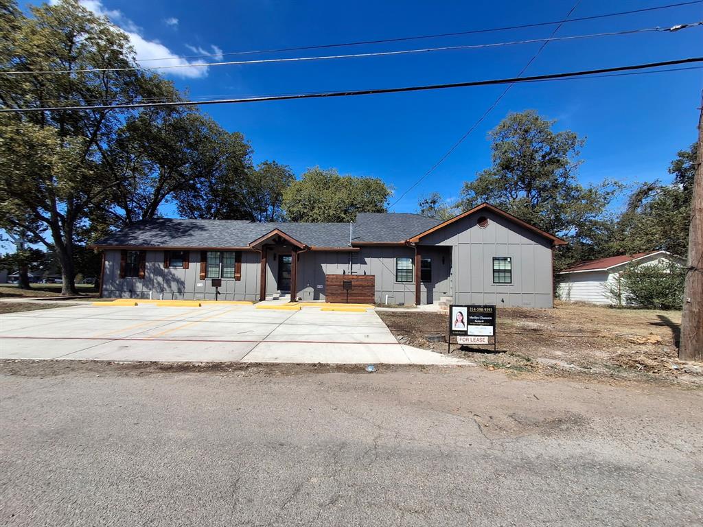 902 Chestnut Street Commerce, TX 75428 - Photo 3 of 18 a view of a house with a yard and a large tree