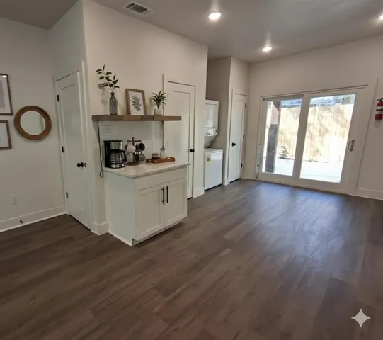 a kitchen with stainless steel appliances granite countertop a stove and wooden floor