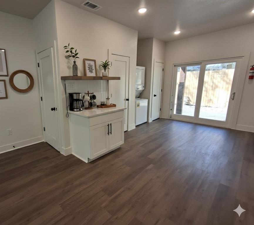 902 Chestnut Street Commerce, TX 75428 - Photo 7 of 18 a kitchen with stainless steel appliances granite countertop a stove and wooden floor