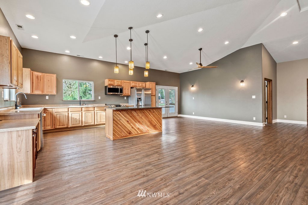 195 Puma Road Longview, WA 98632 - Photo 11 of 39 a large kitchen with stainless steel appliances kitchen island a large counter top and a wooden floors